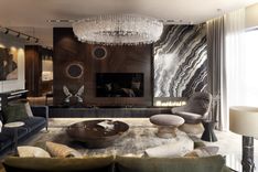 Natural marble slab complemented by a sophisticated bio-fireplace, pouf and Knoll armchair
